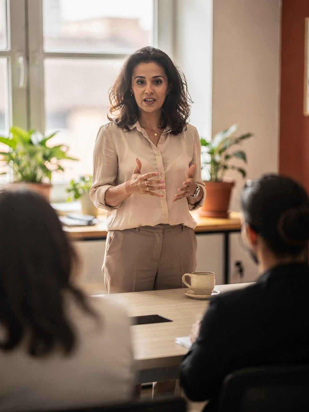 Mentora conduzindo uma sessão presencial para um grupo pequeno em um coworking